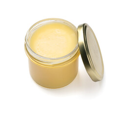 Open glass jar with yellow ghee close up isolatede on white background