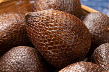 Whole fresh ripe salak, snake fruit close up in a basket 