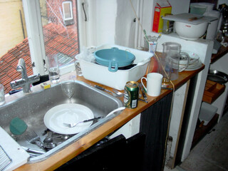 Must have been a fun night A teenagers first apartment. A messy kitchen following a late night.