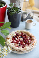 Dessert pizza with raspberries in a plate on the table