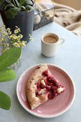 Dessert pizza with raspberries in a plate on the table