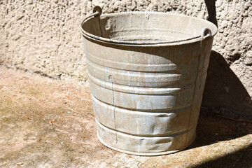 Fototapeta premium Empty metal bucket in the sun