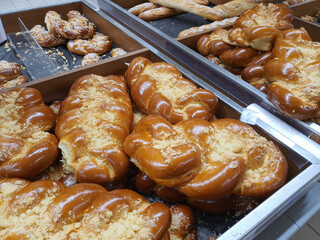 Freshly baked traditional czech sweet vanocka - plaited loaf white bread in bakery or grocery store displayed on shelf. Closeup
