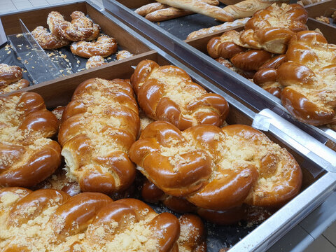 Freshly baked traditional czech sweet vanocka - plaited loaf white bread in bakery or grocery store displayed on shelf. Closeup
