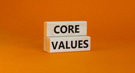 Core values symbol. Concept words Core values on wooden blocks on a beautiful orange table orange background. Business value and core values concept, copy space.