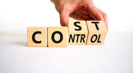 Cost control symbol. Businessman turns wooden cubes and changes the concept word Cost to Control....