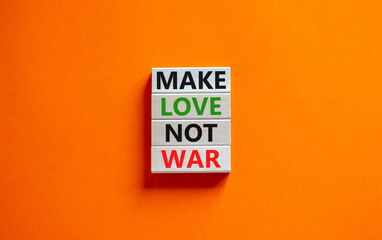 Make love not war symbol. Concept words Make love not war on wooden blocks. Beautiful orange table orange background. Make love not war business concept. Copy space.