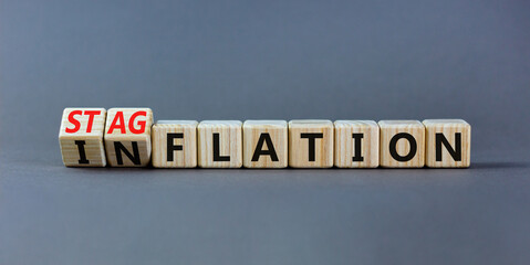 Stagflation or inflation symbol. Turned wooden cubes and changed the concept word inflation to...