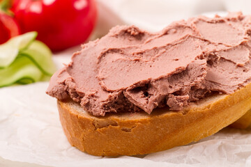 Liver meat pate spread on white bread, on a light background, breakfast, close-up, no people, selective focus,