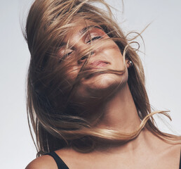 A good hair stylist can fix your hair and your mood too. Shot of a womans hair covering her face...