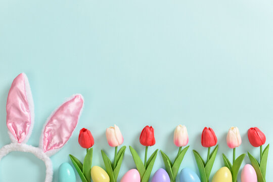 Easter banner with flowers, eggs and ears. Background with rabbit ears