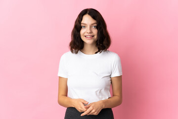 Teenager Ukrainian girl isolated on pink background laughing