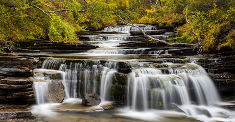 Obraz premium Waterfall in autumn forest, Sweden