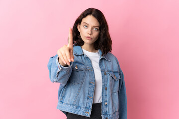 Teenager Ukrainian girl isolated on pink background counting one with serious expression