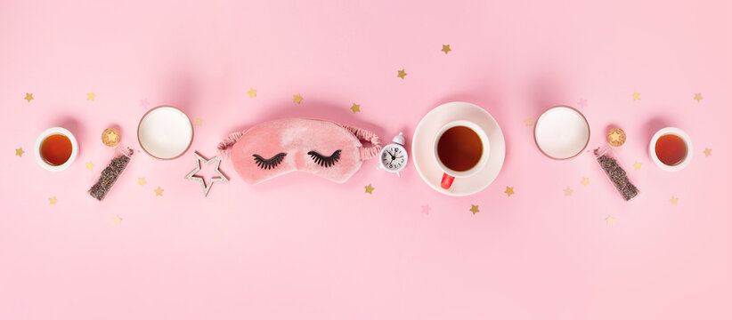 World Sleep day observed every year in March. Cute sleeping mask and alarm clock on pink pastel background, top view.