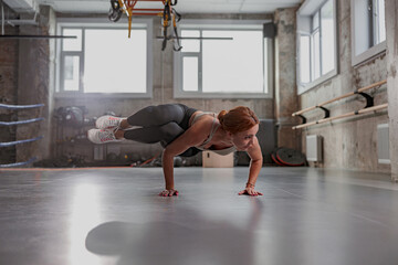 Fototapeta na wymiar Beautiful woman doing yoga alone at gym