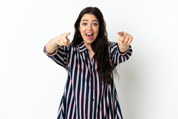 Young caucasian woman over isolated background surprised and pointing front