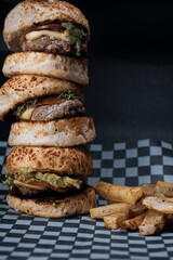 Three mini burgers on black background