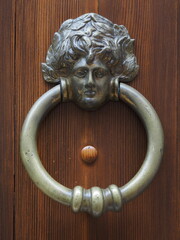Wooden door, detail. Old door knocker.