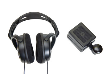 A morse code key and black headphones