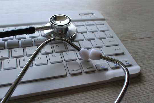 Selective focus image of stethoscope and keyboard. Medical and technology concept.