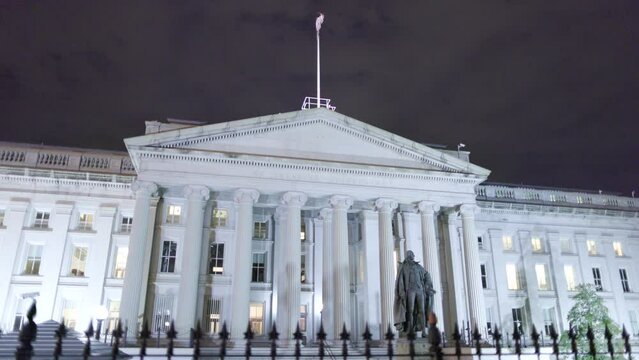 North Entrance Of The U.S. Department Of The Treasury Building And Albert Gallatin Statue In Downtown Washington, D.C. Seen In A Nighttime Shot.