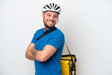 Young brazilian man with thermal backpack isolated on white background with arms crossed and happy