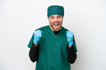 Surgeon Brazilian man in green uniform isolated on white background celebrating a victory in winner position