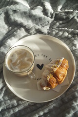Croissant with coffee for breakfast. Breakfast in bed.