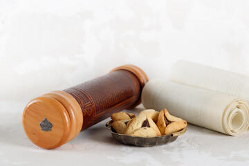 Scroll of Esther and haman's ears cookies. Hebrew inscription Megillat Esther. Israeli holiday Purim