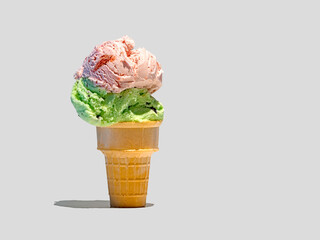 Double scoop ice cream cone with Strawberry and Mint Chocolate Chip ice cream.