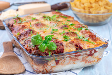 Mac and cheese with meatballs, mozzarella, tomato sauce and basil, in backing dish, horizontal
