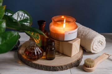 beauty treatment items for spa procedures on white wooden table, soap, candle, , essential oils. Copy space
