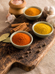 Indian spices on wooden background.