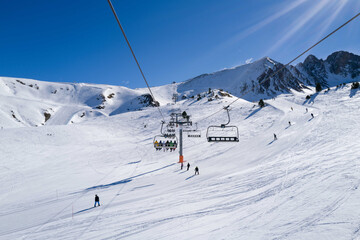 People riding ski lift in ski resort