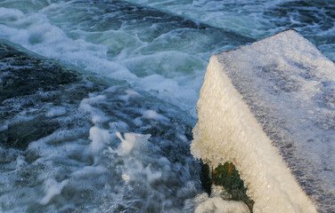Water Cascading over Weir Step in river canal.