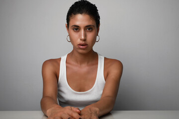 Young confident woman with beautiful skin looking at the camera. Isolated.