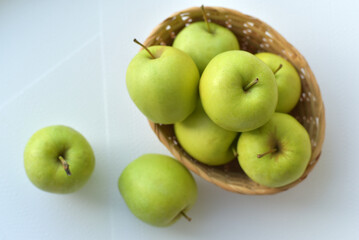 Juicy green apples in a basket
