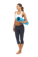 Fototapeta premium Pilates keeps her feeling great. Cute young woman holding an exercise mat against a white background.