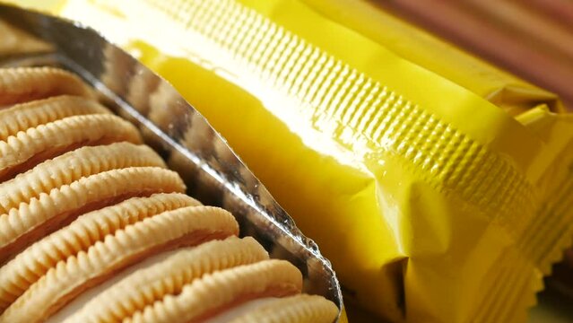 close up of cheese cookies in a yellow packer on table 