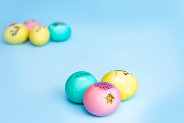 Bright multi-coloured painted Easter eggs on a blue background. Easter
