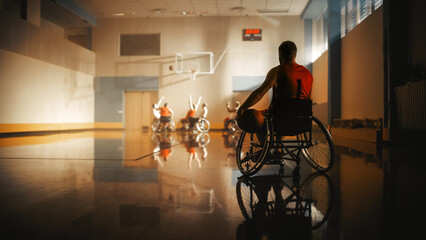 Wheelchair Basketball Game: Player Wearing Red Shirt Holding Ball Waiting for His Turn. Athlete Watching His Team Play. Determination, Motivation of People with Disability Excelling at the Sport.