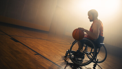 Wheelchair Basketball Player Wearing Red Uniform Leads Ball Successfully to Score a Perfect Goal. Determination, Training, Inspiration of a Person with Disability. Wide Shot with Warm Colors