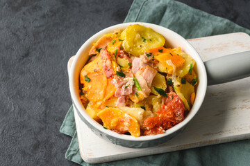 Casserole of potatoes, sweet potatoes, zucchini, tomatoes, onions and bacon