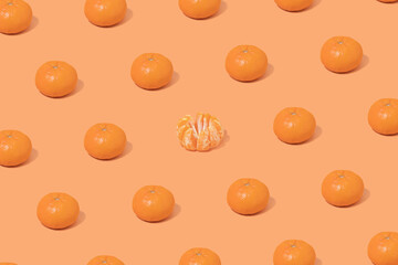 Fototapeta na wymiar Peeled mandarin in the company of the mandarins on orange backround.
