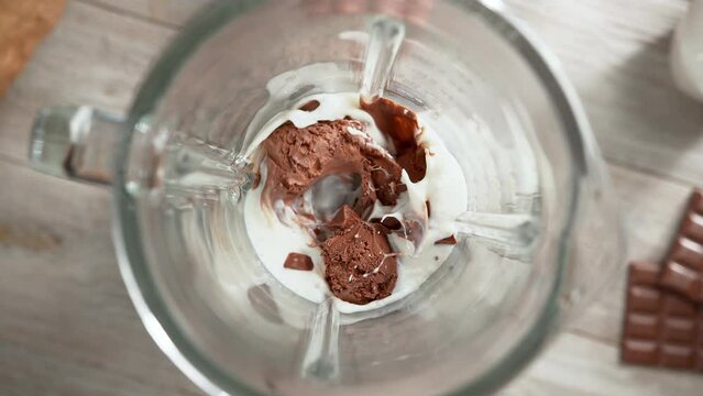 Chocolate Ice Cream Milkshake Mixed in Blender in Slow Motion - Top View, Camera Moves Out