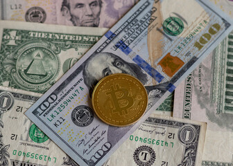 Bitcoin over dollar bill closeup