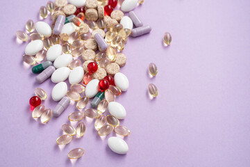 Vitamins and tablets in bulk on a pink background