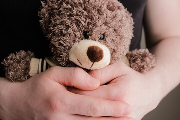 Boy alone at home with teddy bear