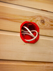 Plastic nest for an indoor socket in a wall sheathed in wood